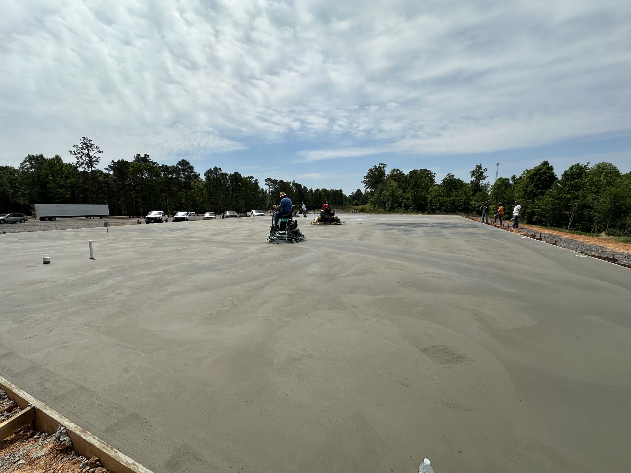 Experienced crew finishing a large concrete slab